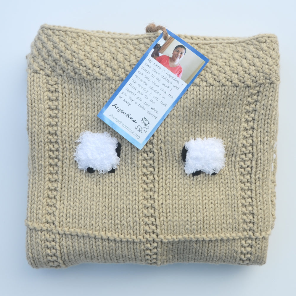 Folded baby blanket in barley color (light tan)