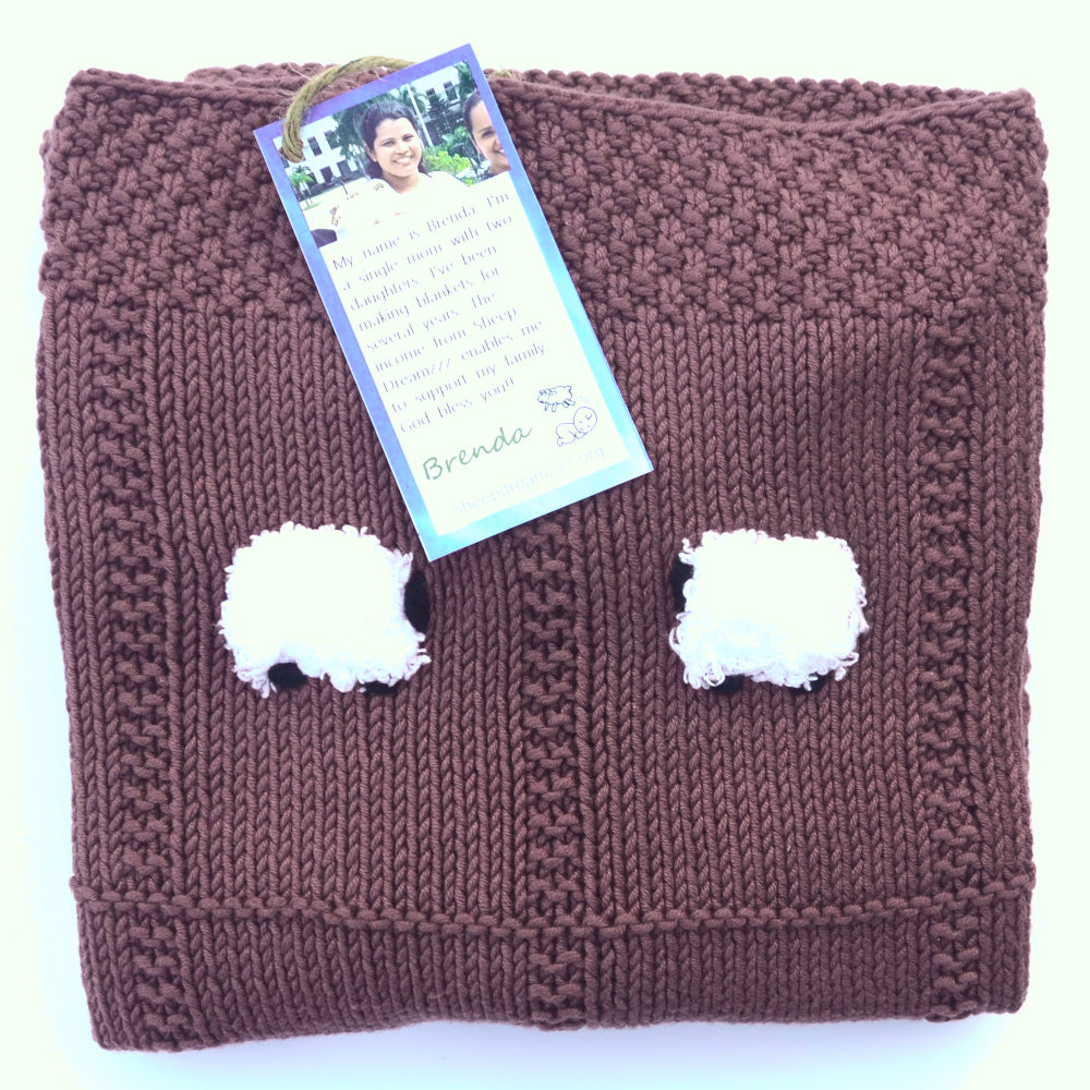 Red sangria color lightweight baby blanket, hand-knitted, with white fluffy sheep.
