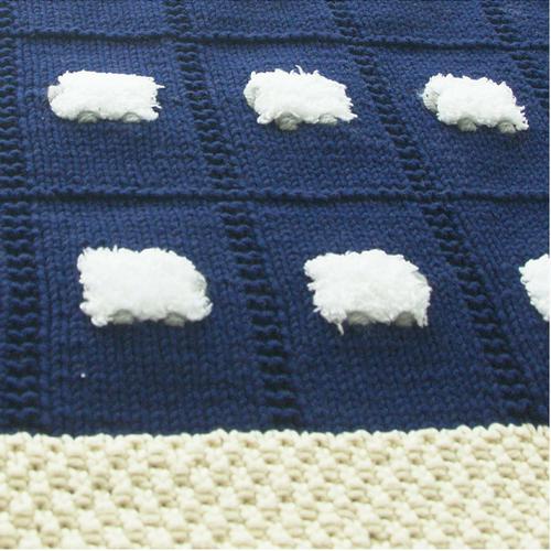 Close-up of navy blue baby blanket with a cream border