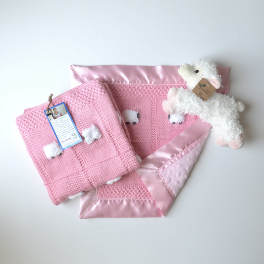 Baby blanket gift set in bubble gum pink, with a blanket, a lovey, and a fluffy sheep doll.