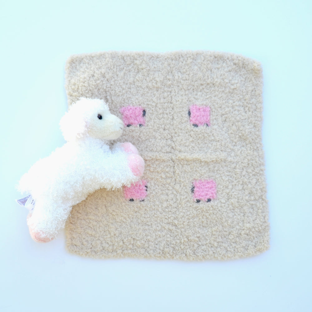 Sherpa baby lovey, oatmeal in color, with four fluffy pink sheep.