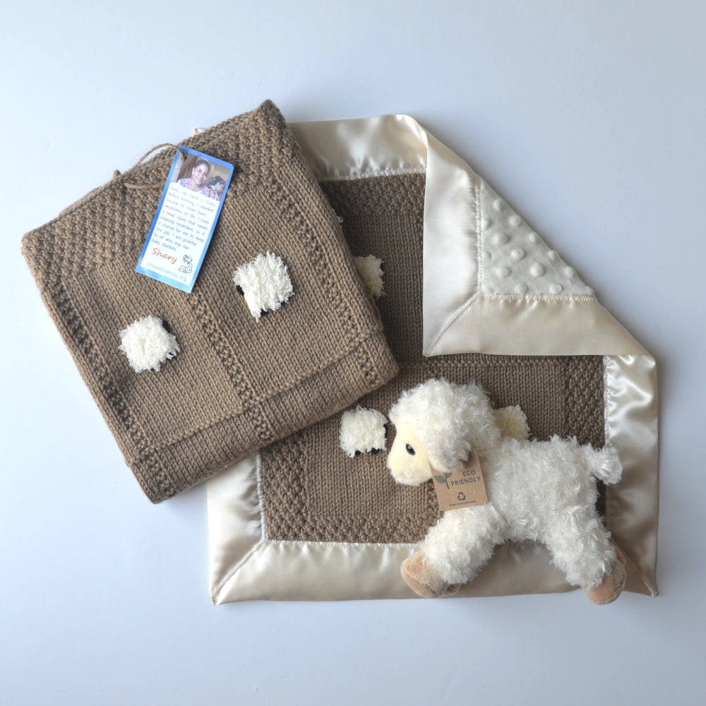 Khaki baby gift set featuring a baby blanket, a lovey, and a fluffy sheep doll.