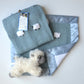 Baby gift set in moonstone blue, with a hand-knitted baby blanket, lovey, and sheep doll.