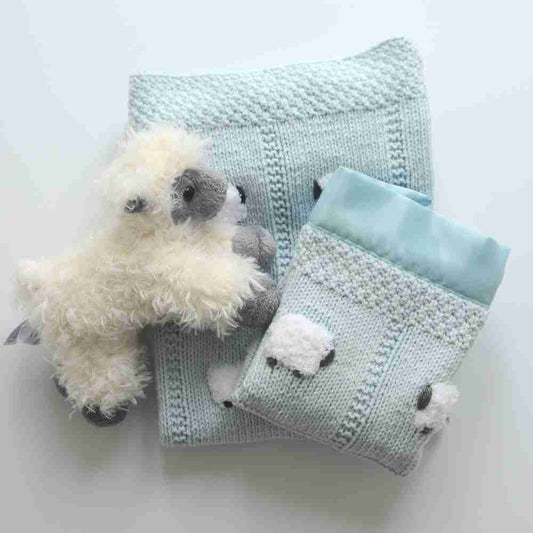 Pastel blue baby blanket gift set with a lovey and fluffy sheep doll.