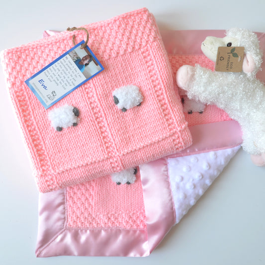 Bright peachy pink baby gift set with blanket, lovey, and sheep doll