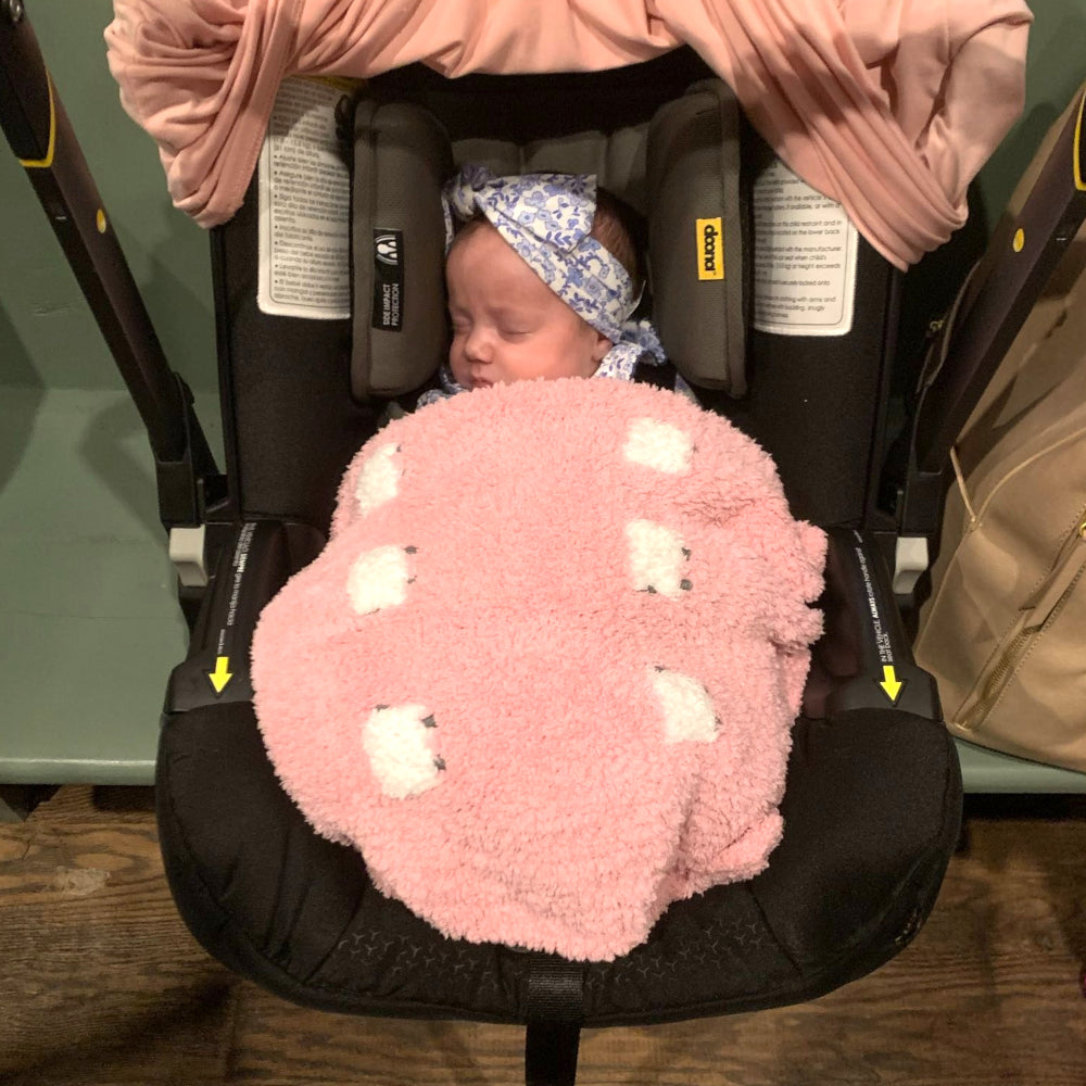 Baby with pink sherpa blanket
