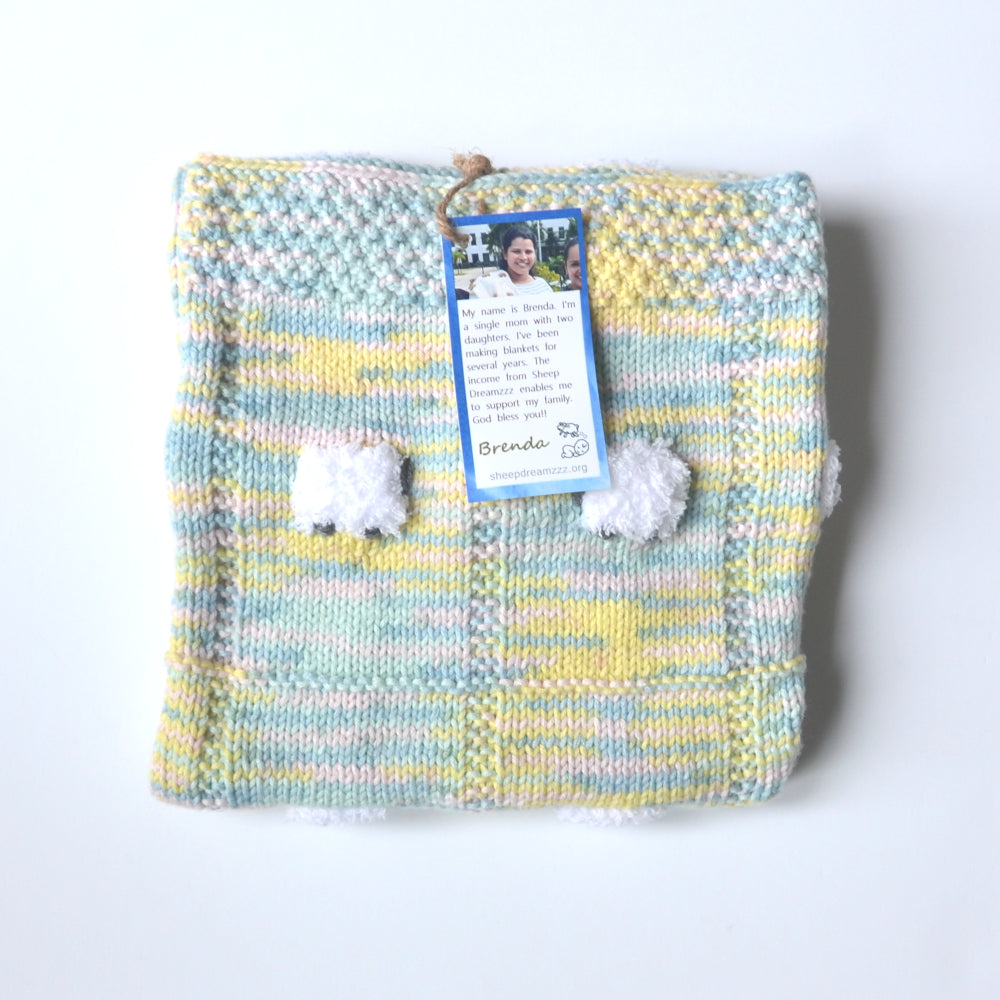 Baby blanket with blue, yellow, pink, green.