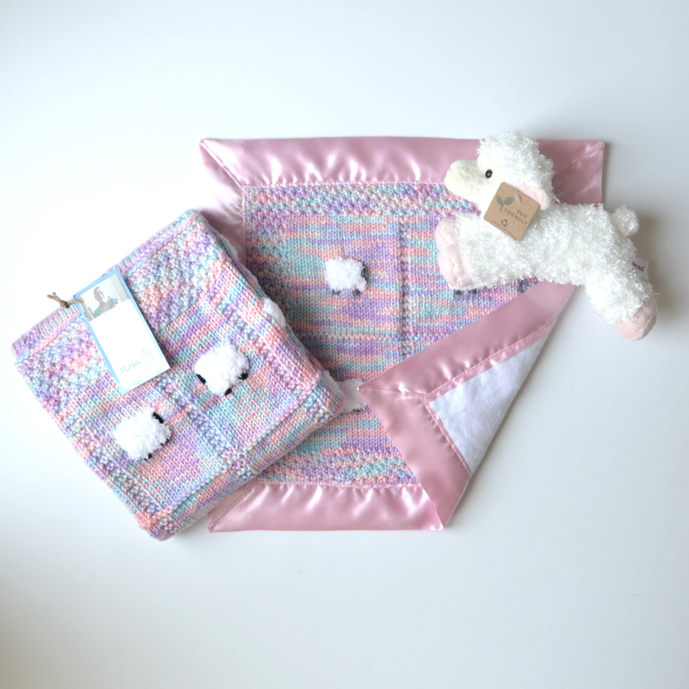 Baby blanket gift set with yarn that is purple, lavender, and aqua. Shown are blanket, a lovey, and a pink-tinged sheep doll.