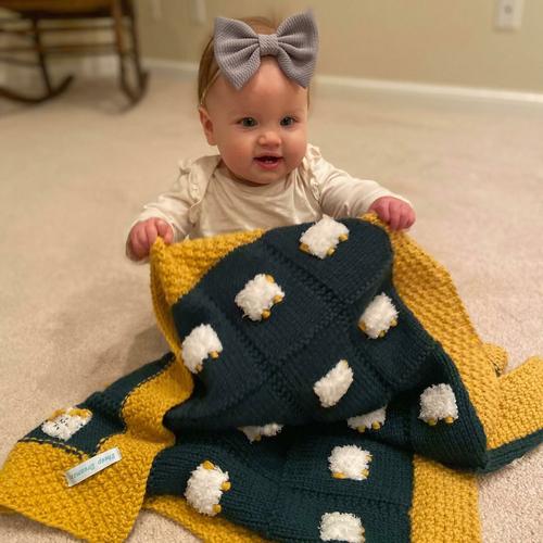 Baby with a custom baby blanket in Green Bay Packers colors