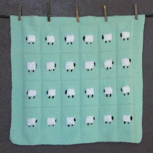 Pastel green baby blanket with 24 fluffy white sheep