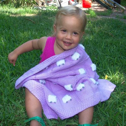 Very young girl happy with her periwinkle baby blanket
