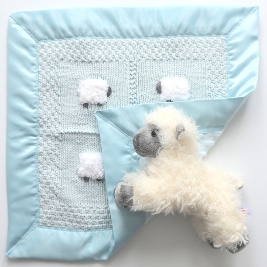 Pastel blue hand-knitted lovey blanket with a fluffy sheep doll