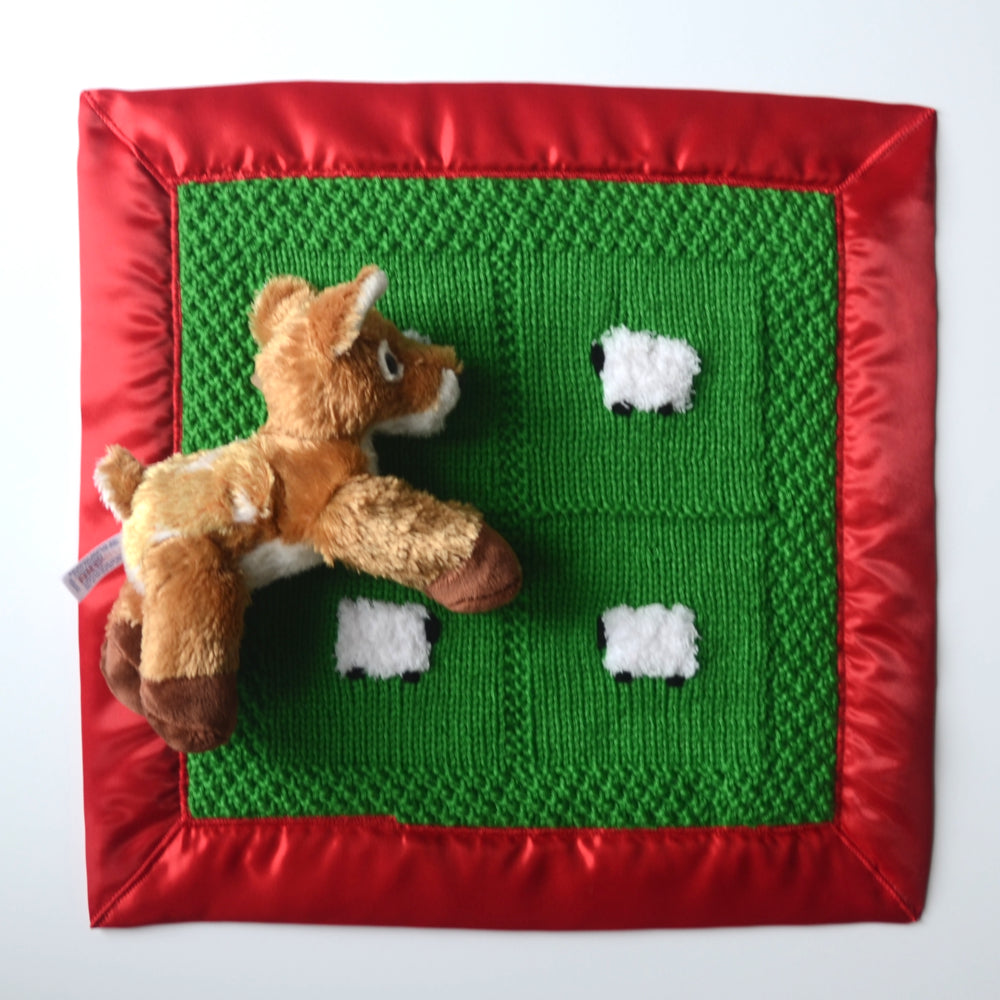 Christmas baby lovey with bold green and red, and a soft and fluffy fawn doll.