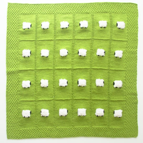 Bright green handmade baby blanket with 24 fluffy white sheep