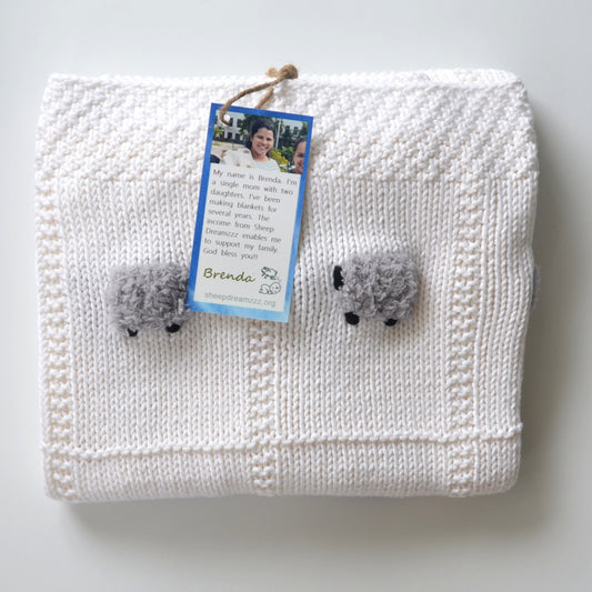 Solid pure white lightweight baby blanket with fluffy gray sheep.