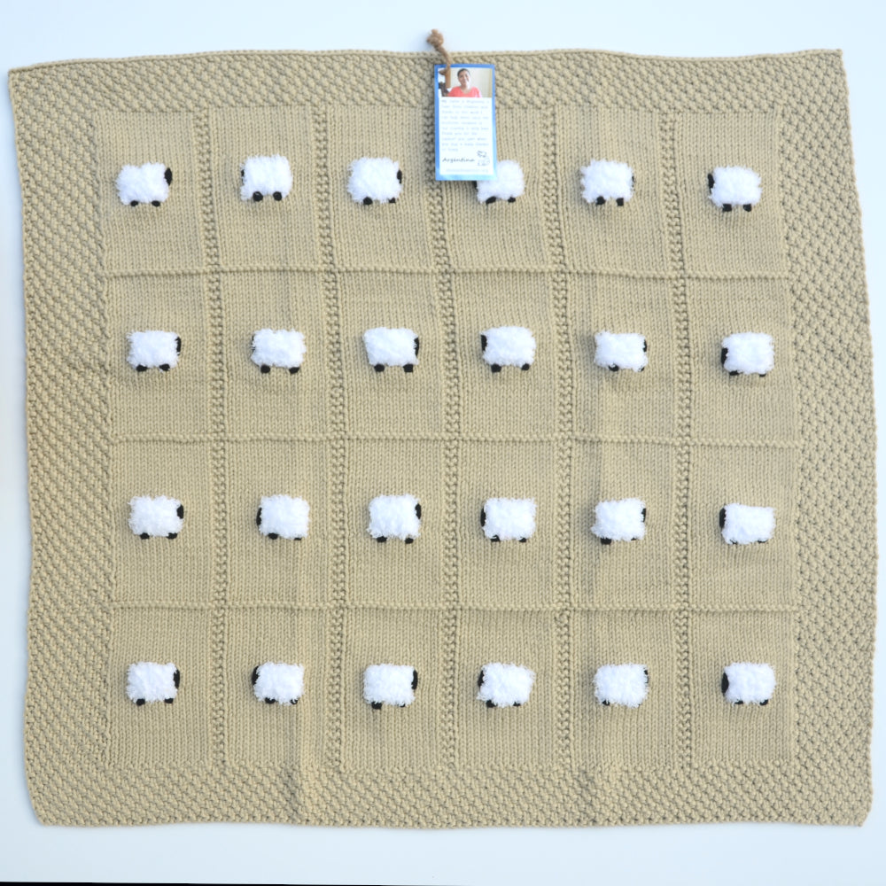 Baby blanket laid flat. It is square and barley-colored with 24 fluffy sheep.