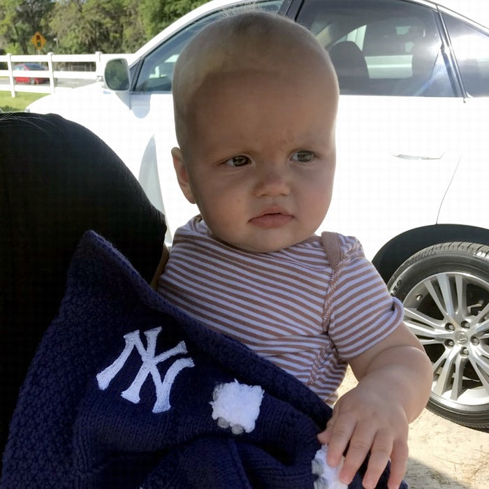 Here's a navy blue blanket where we left one sheep off so we could embroider a New York Yankees logo. If you want something like this in one of the squares, we have to leave a sheep off - easy to do but we can't remove it after the blanket has been made.