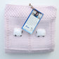 Folded hand-knit baby blanket in pink.