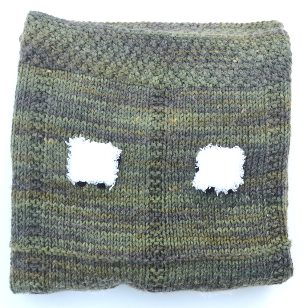 Dark green baby blanket that is hand-knitted with 24 fluffy sheep.