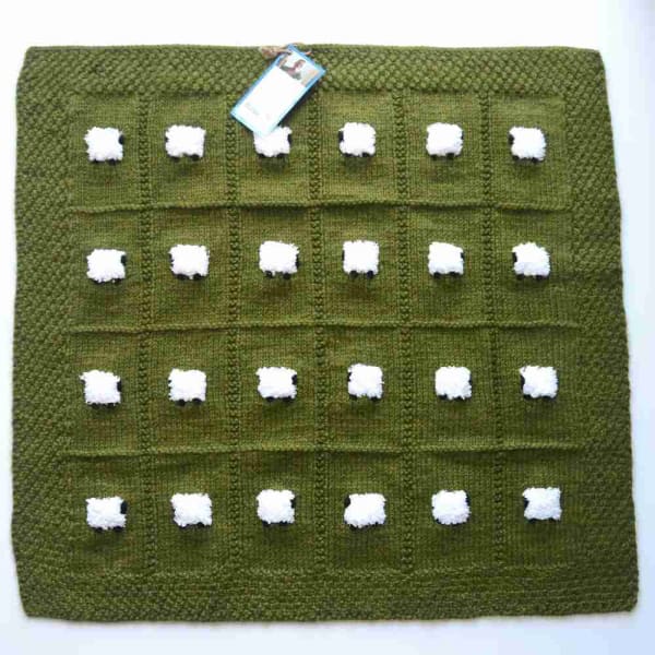 Fennel Green wool-based baby blanket with 24 fluffy sheep - all knitted by hand.