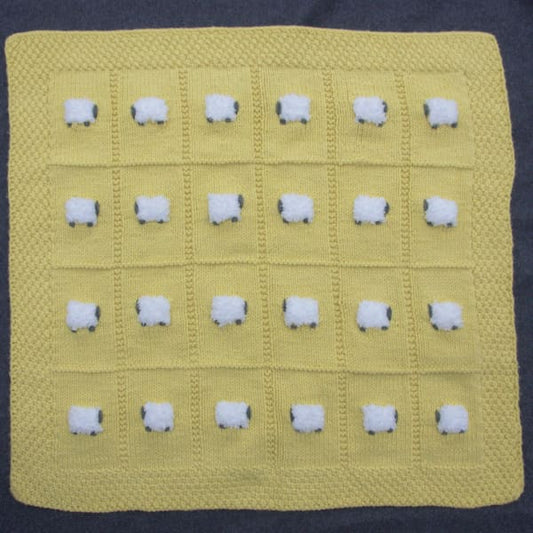Warm yellow wool-based baby blanket with 24 fluffy sheep - all knitted by hand.