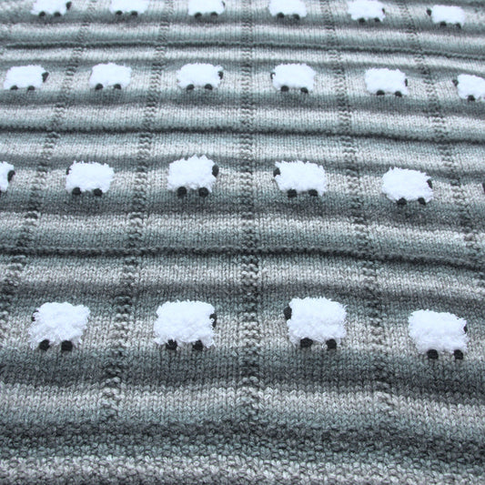 Warm wool-based baby blanket with horizontal stripes of light gray, charcoal, and forest green.