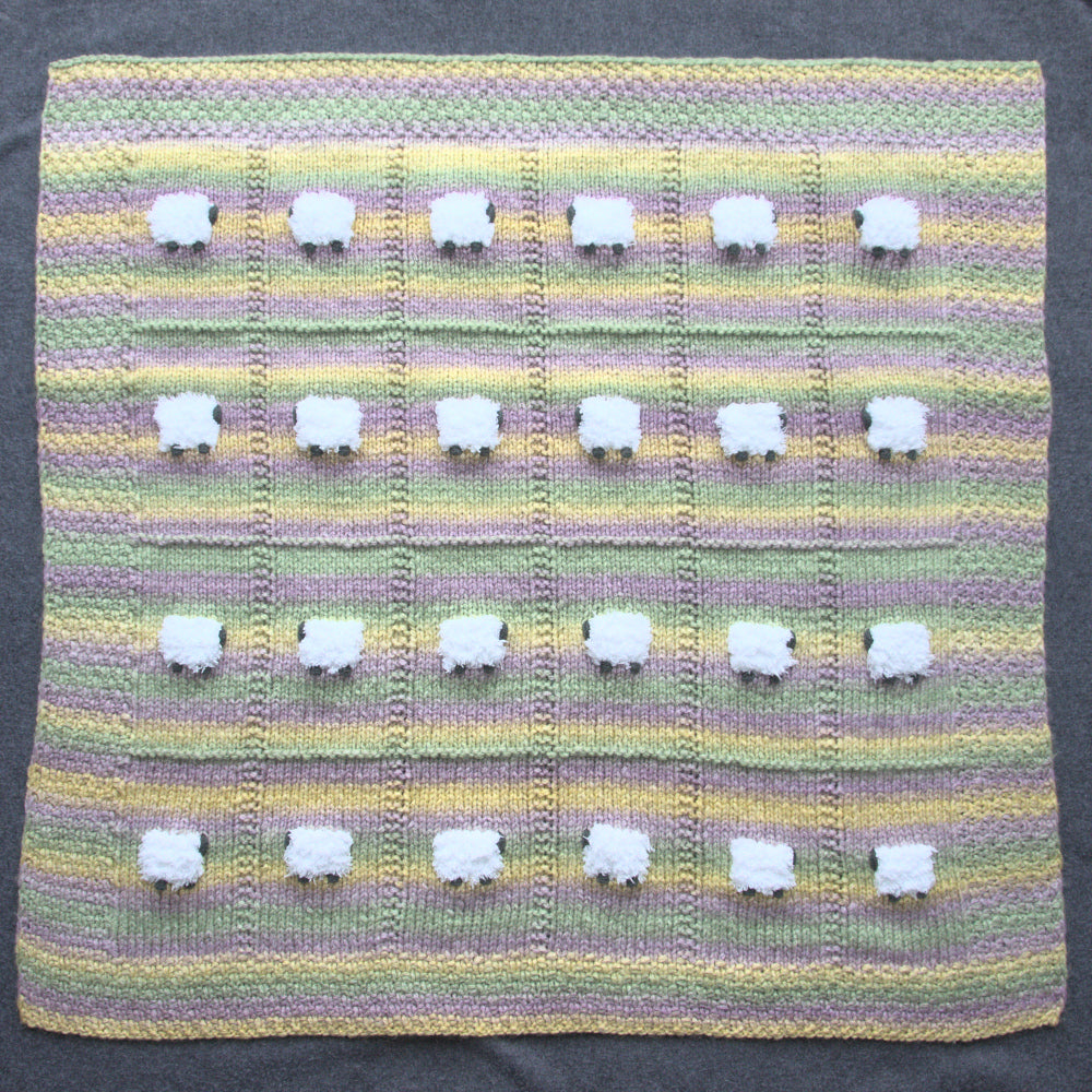 Warm wool-based baby blanket with horizontal stripes of light green, lavender, and yellow.