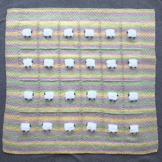Warm wool-based baby blanket with horizontal stripes of light green, lavender, and yellow.