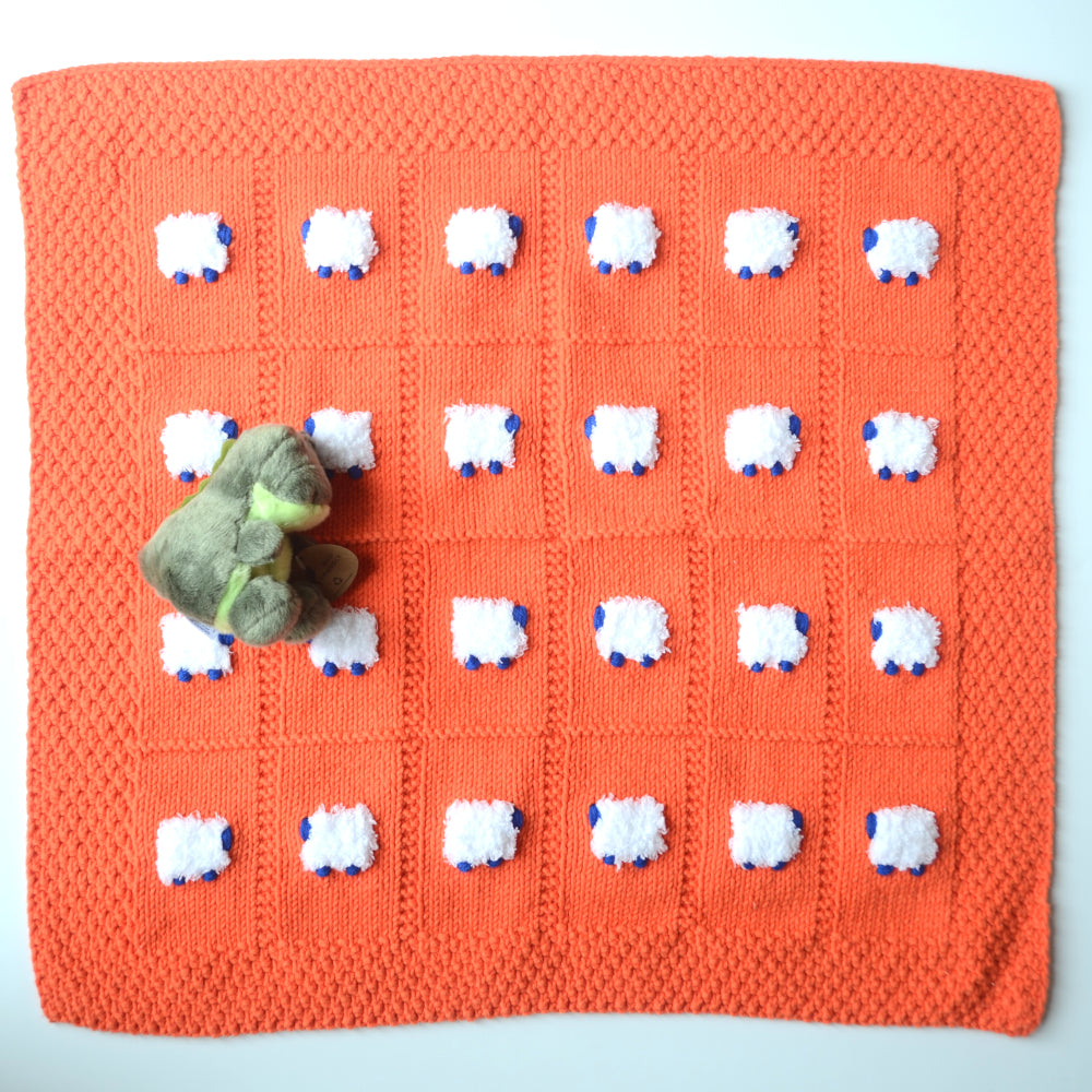 Orange blanket with white fluffy sheep that have blue heads and feet. For your babygator UF little one.