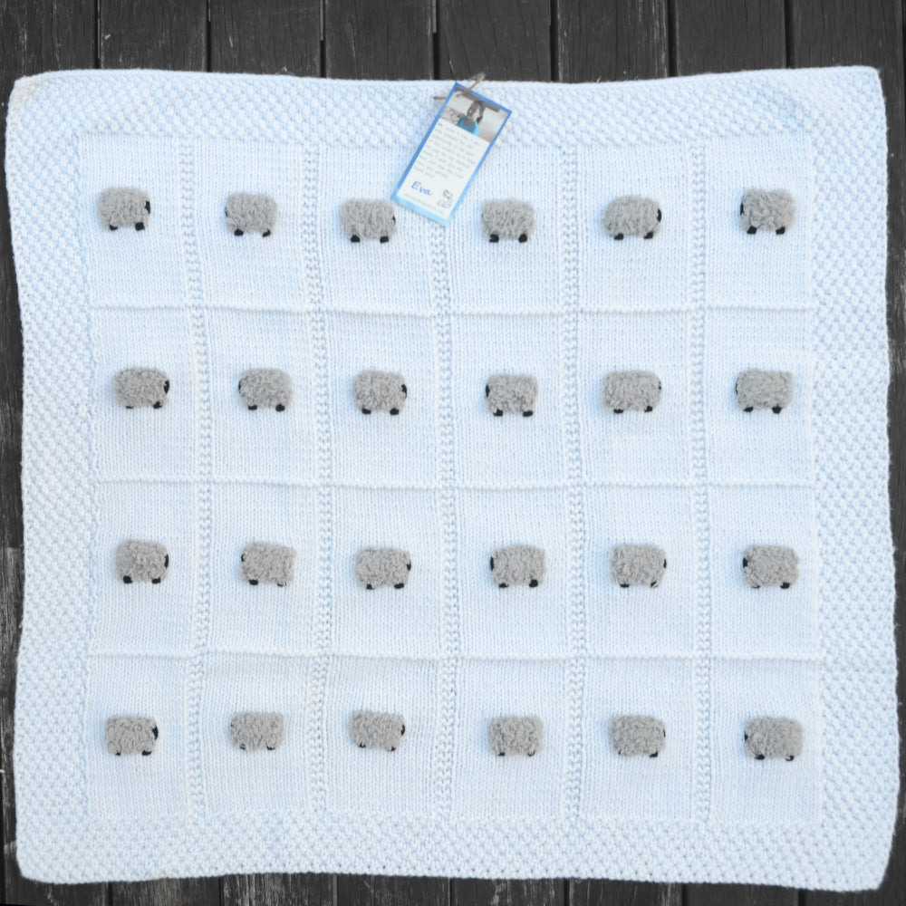 White baby blanket with 24 fluffy gray sheep.