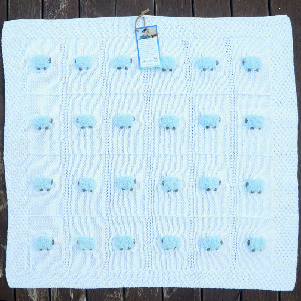 White baby blanket with 24 fluffy blue sheep. All cotton.